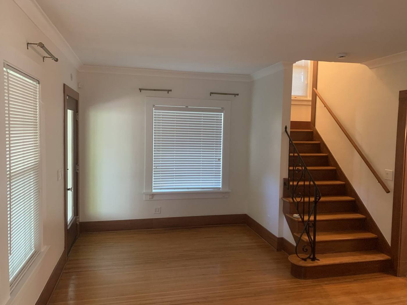 Living room with stairway and wood floors