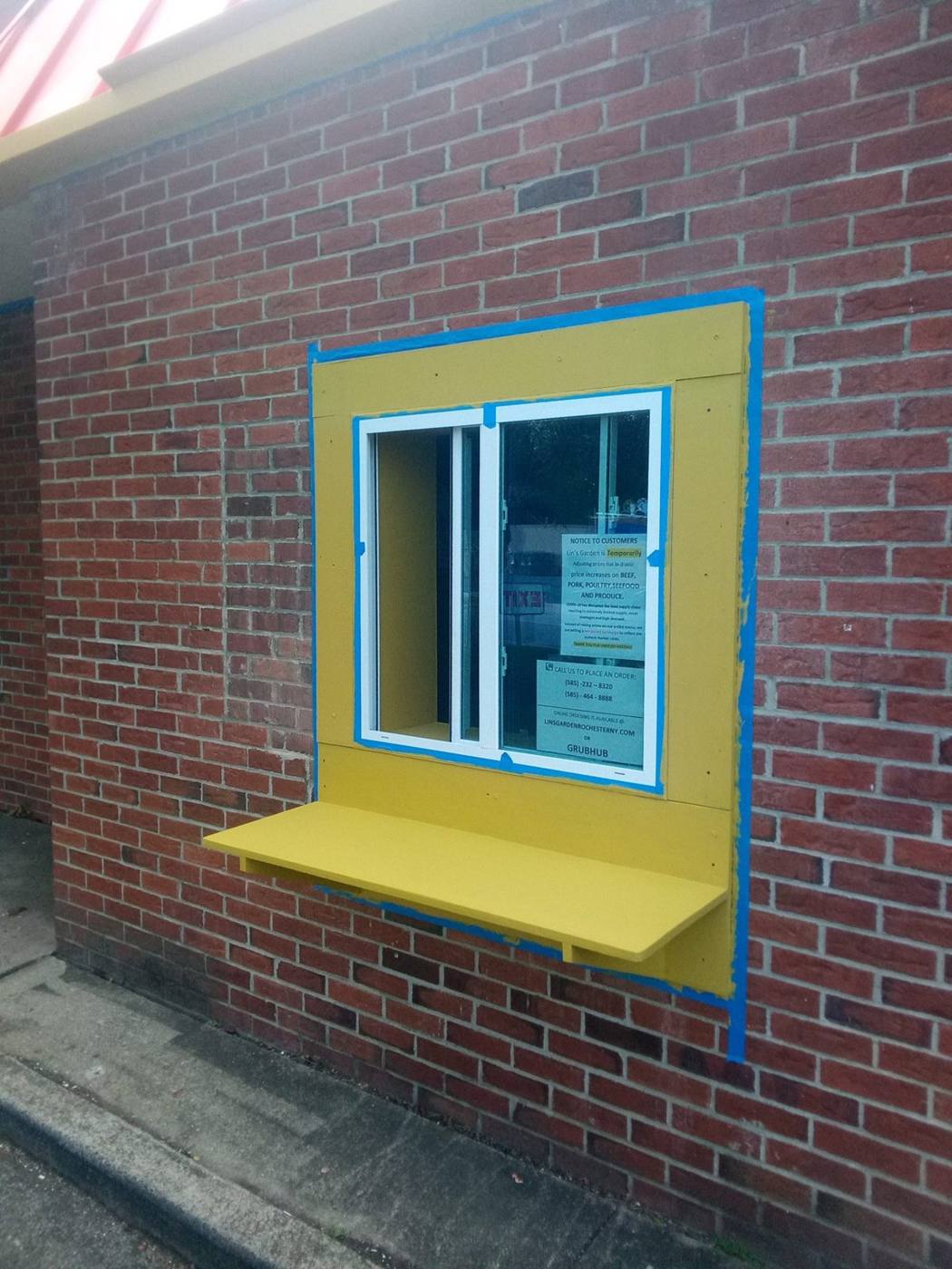 Yellow window trim on red brick